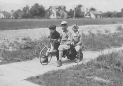 Three Bockstanz children on bicycle: Ruth (left), John, Bruce, c. 1930