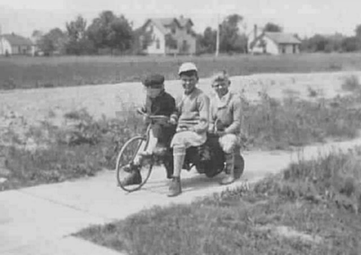 Three Bockstanz children on bicycle: Ruth (left), John, Bruce, c. 1930